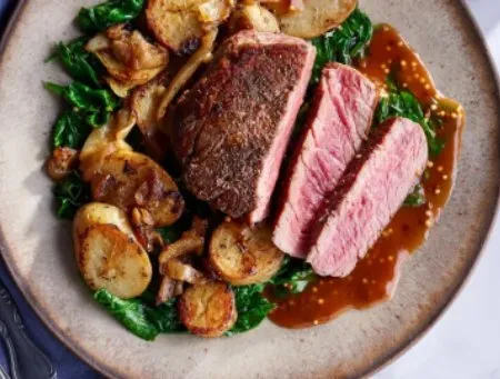 Steaks with Dijon glaze Lyonnaise potatoes and wilted spinach sunbasket